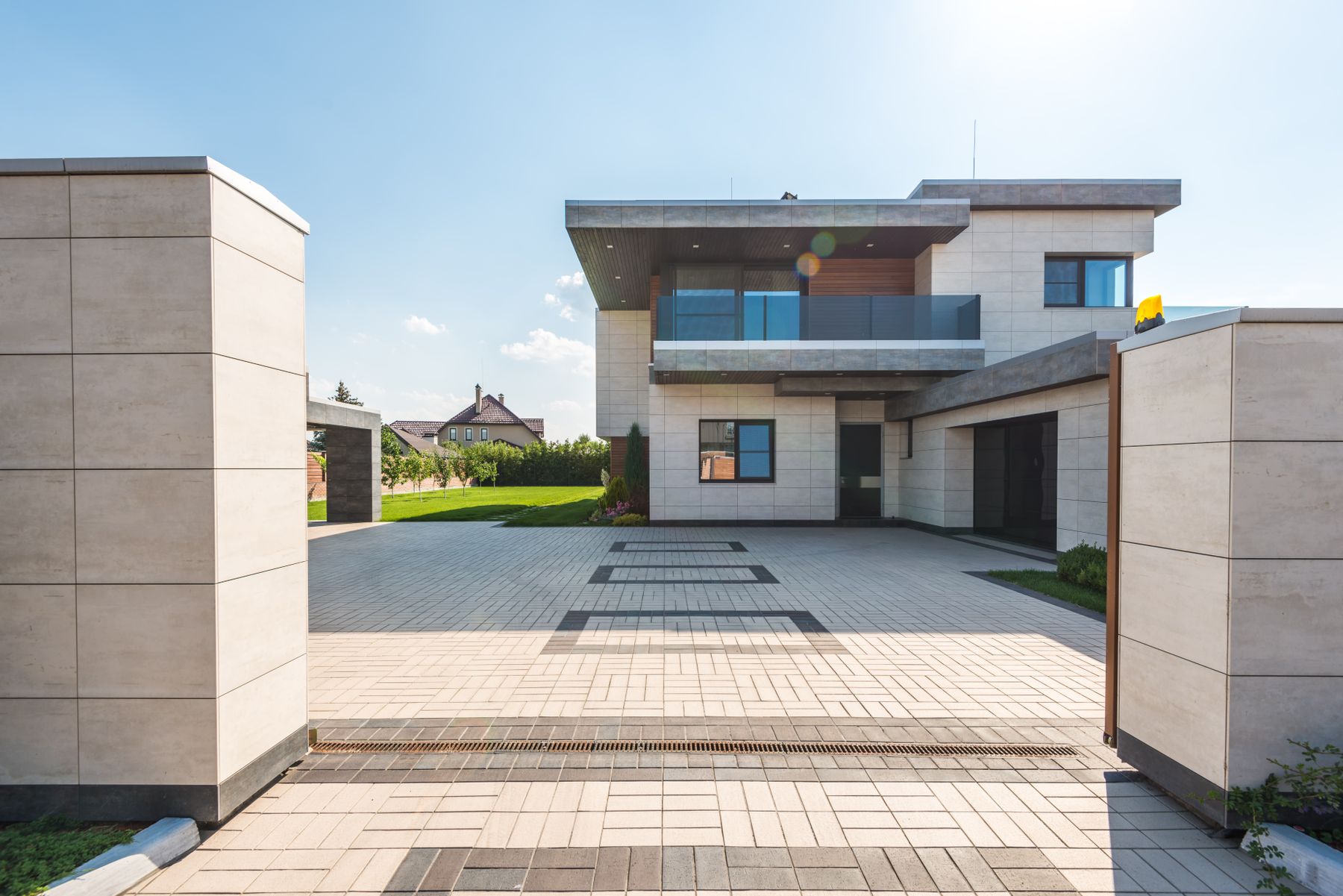 Contemporary detached home with a paved forecourt on a bright day