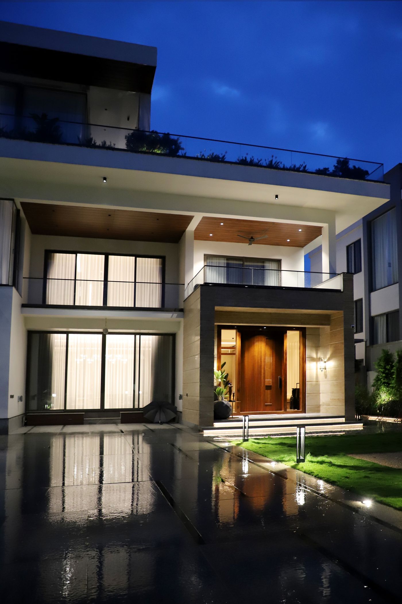 Contemporary home lit warmly at dusk